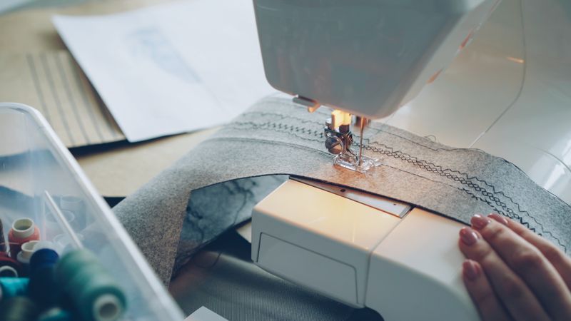 Detailed view of a sewing machine stitching fabric.
