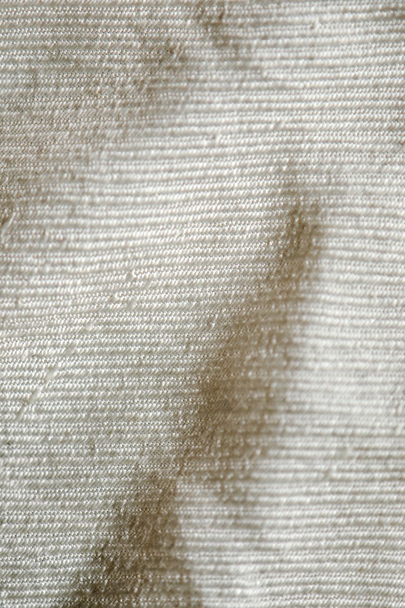 Soft white textile texture with fine details.