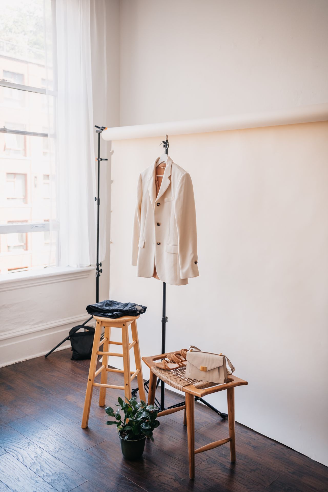 Stylish beige blazer and accessories displayed against a neutral backdrop.